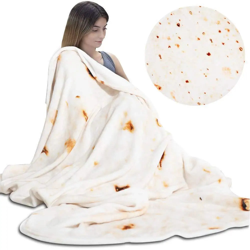 A white blanket throw with brown stains is draped over a person, next to a circular piece of pizza dough.