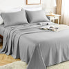 A gray luxury solid stripe bedding set featuring a duvet and pillows on a bed.