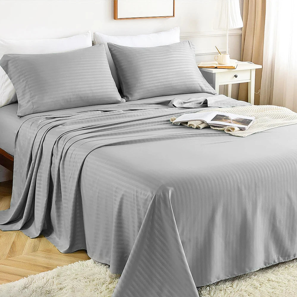 A gray luxury solid stripe bedding set featuring a duvet and pillows on a bed.