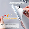 Hands are removing a backing film from a reflective mirror window film to apply it to glass.