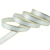 White satin ribbon with gold edges rolled into several strands for gift wrapping and crafts