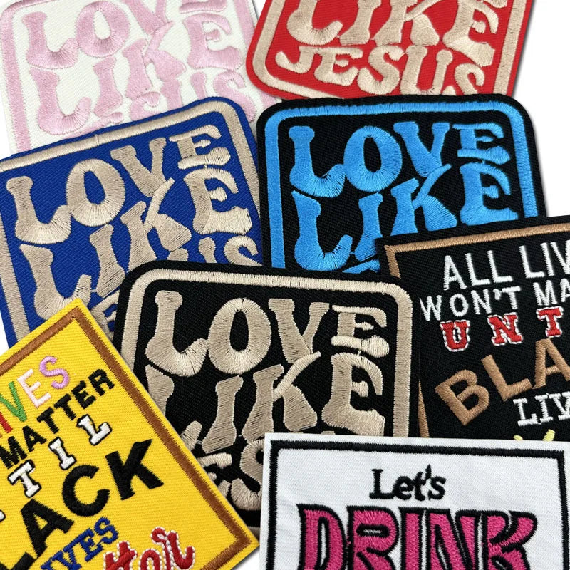 A collection of embroidered iron-on clothing patches featuring text like Love Like Jesus and Let's Drink.