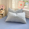 A light blue duvet cover set with matching pillows and a framed sign reading Good Time on a bed.