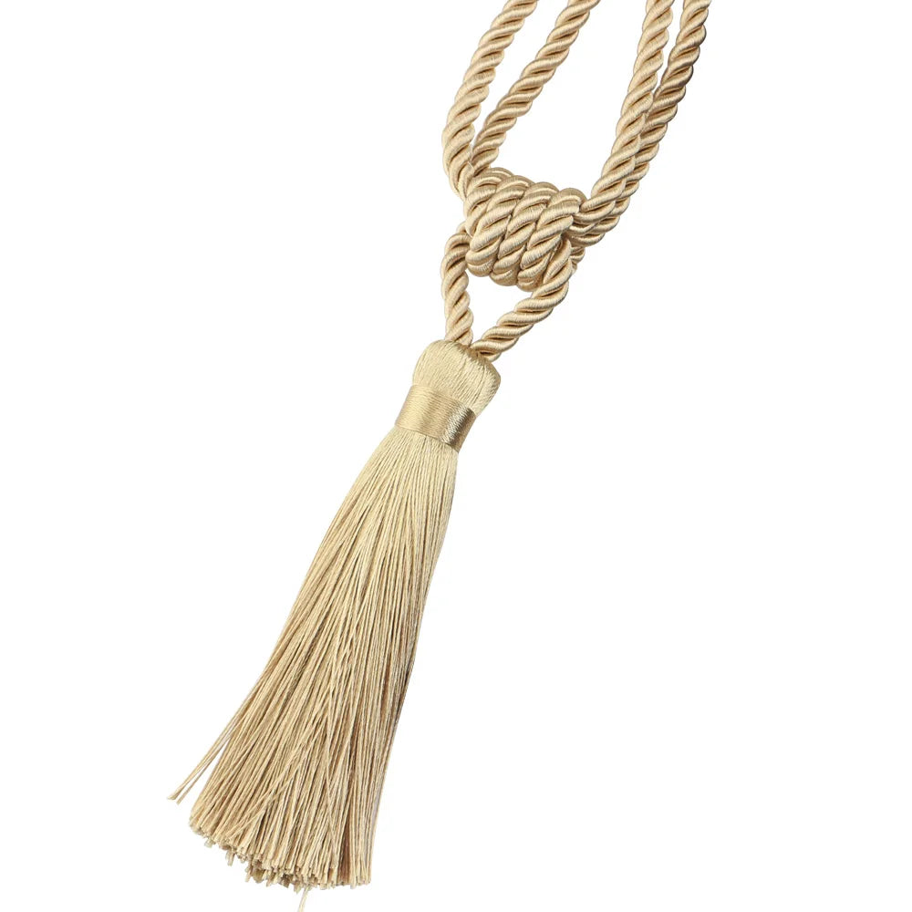 Elegant curtain tiebacks made of beige rope with decorative tassels