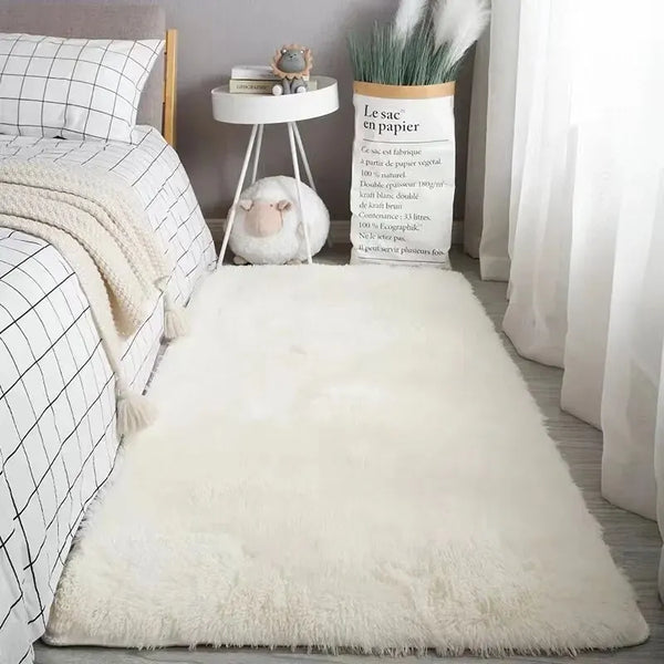 A fluffy white faux fur rug placed on a light wood floor with decorative elements and a potted plant.