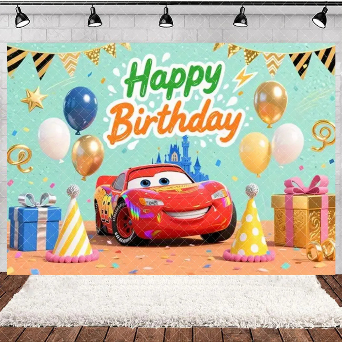 A colorful birthday party backdrop featuring a cartoon red race car, balloons, and festive decorations.