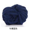 A ball of dark navy blue chunky acrylic yarn for knitting and crochet projects.