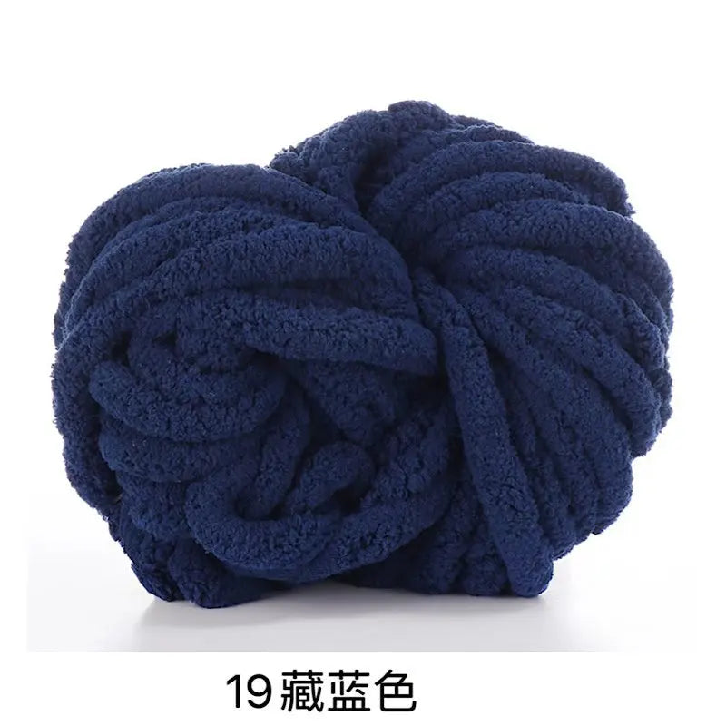 A ball of dark navy blue chunky acrylic yarn for knitting and crochet projects.
