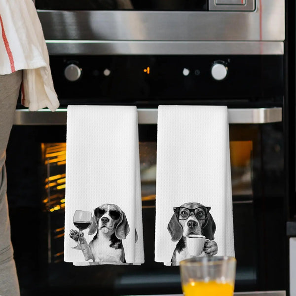 A set of white kitchen towels featuring illustrations of dogs with glasses and a cup.