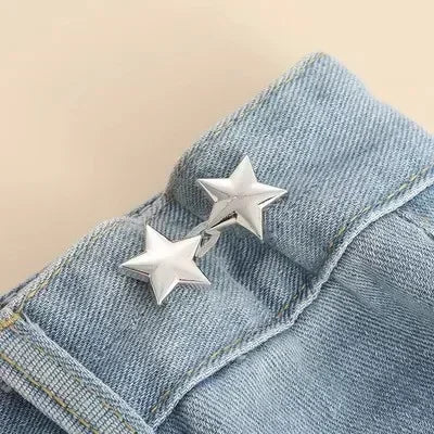 Silver metal star brooch pins attached to a blue denim fabric