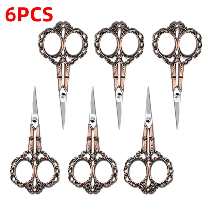 Six pieces of durable stainless steel crafting scissors with ornate handles and sharp blades.