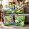 A collection of five floral throw pillows featuring various green, pink, and yellow wildflowers on a light green background.