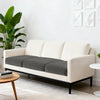 A modern beige sofa with dark gray seat cushion covers in a contemporary living room setting.