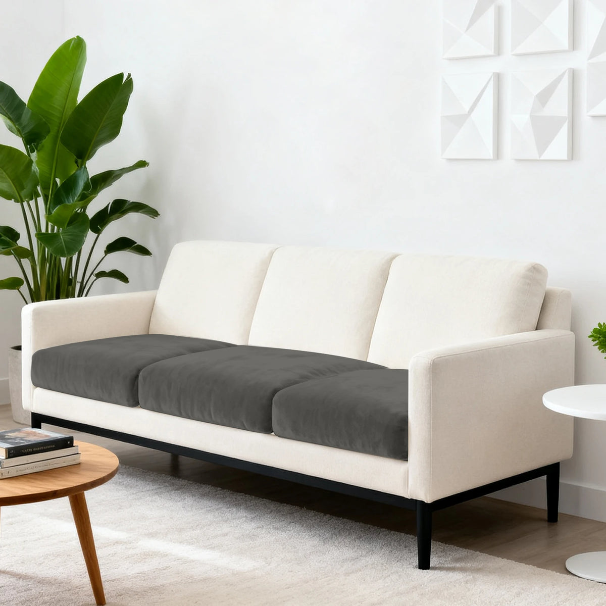 A modern beige sofa with dark gray seat cushion covers in a contemporary living room setting.