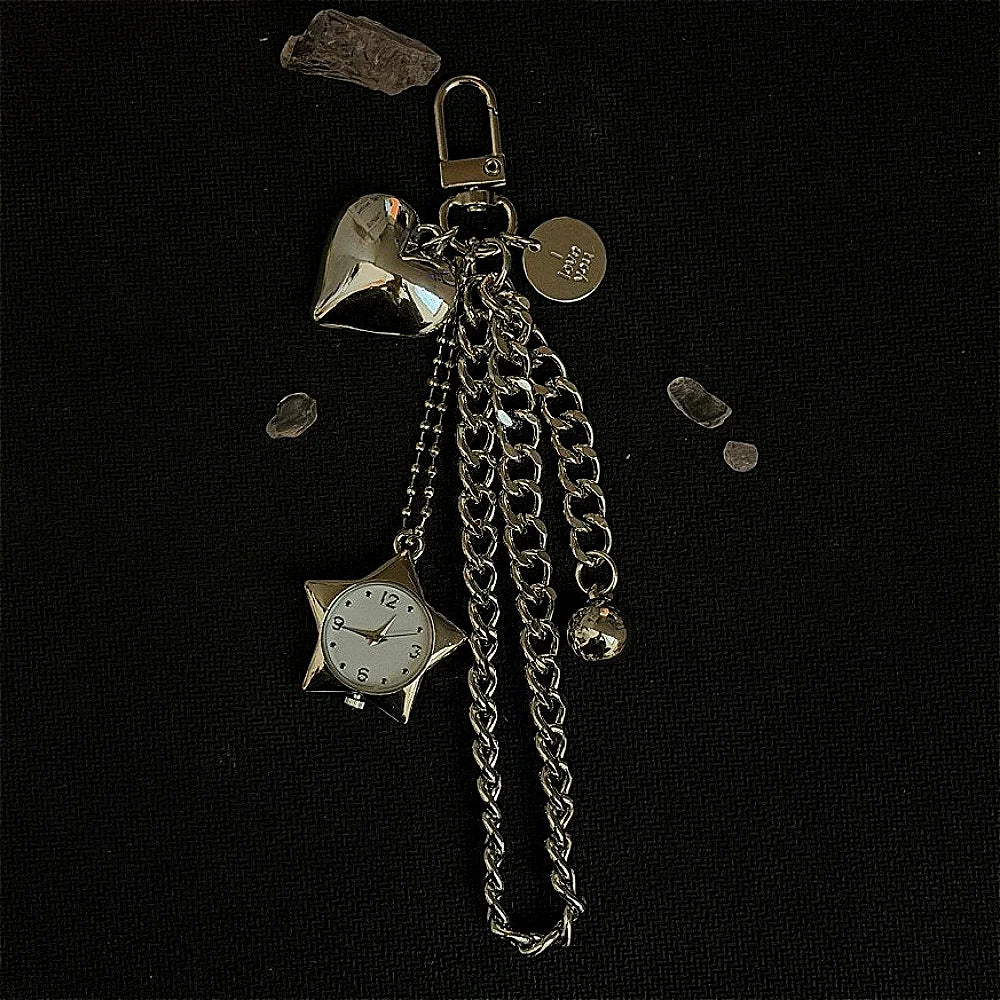 Silver star-shaped pocket watch keychain with a chain and a small bell.