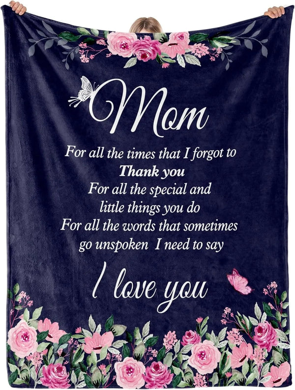 A dark blue velvet throw blanket featuring pink and purple floral embroidery with the text I love you