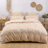 A beige bohemian grid tufted duvet cover set displayed on a bed with natural fiber accents.