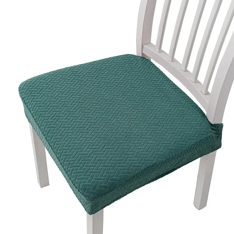 Teal quilted seat cover on a white wooden chair.