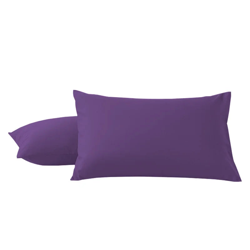 A pair of solid purple microfiber pillow covers.