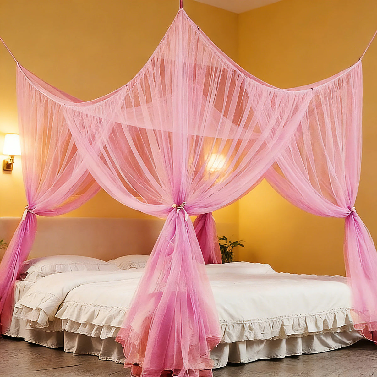 Pink mosquito net bed canopy draped over a white bed in a yellow room.