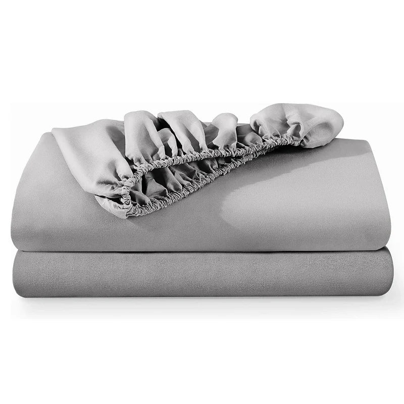 A folded light gray luxury Egyptian cotton fitted bed sheet with gathered fabric detail.
