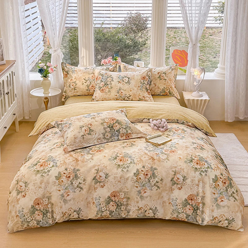 A beige floral cotton duvet cover and pillow set displayed on a bed with sheer curtains and natural light.