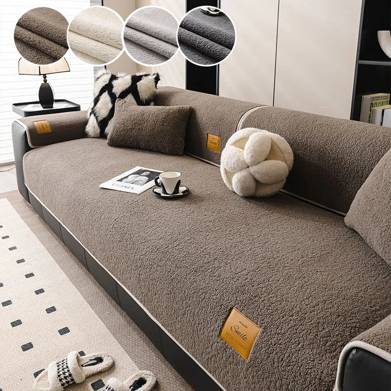 A brown fleece sofa mat with decorative pillows and a small cup on the surface.