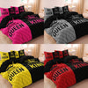 A set of pink and black duvet covers featuring a crown print for a couple's bedding.