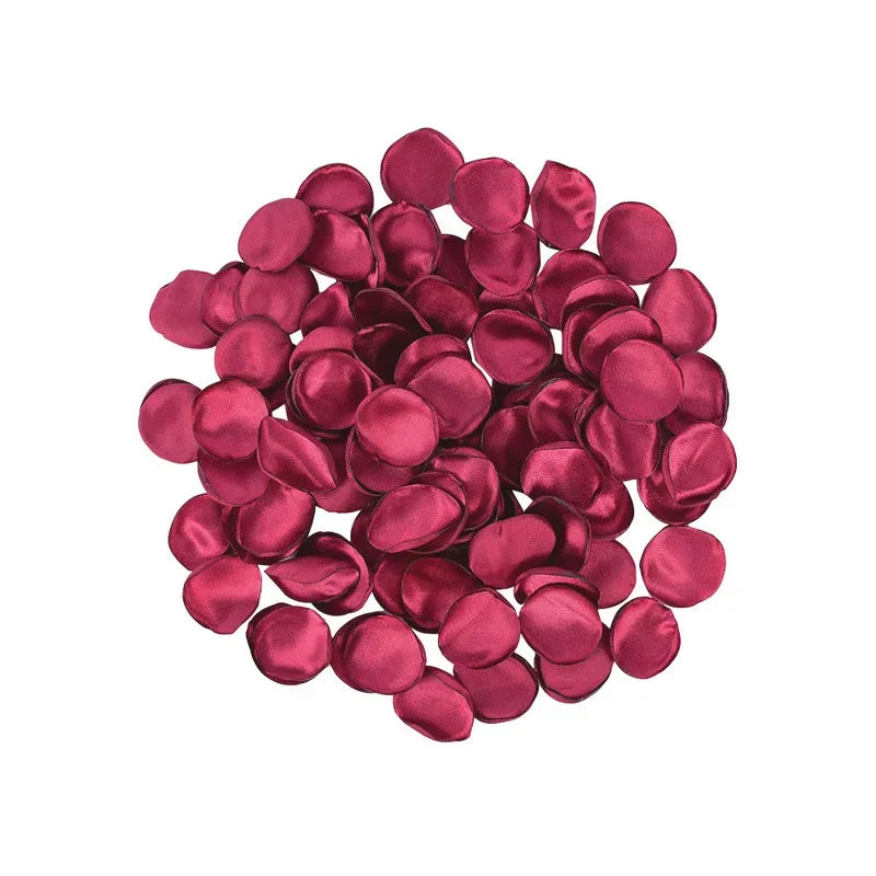 A pile of deep magenta silk rose petals for weddings and events.