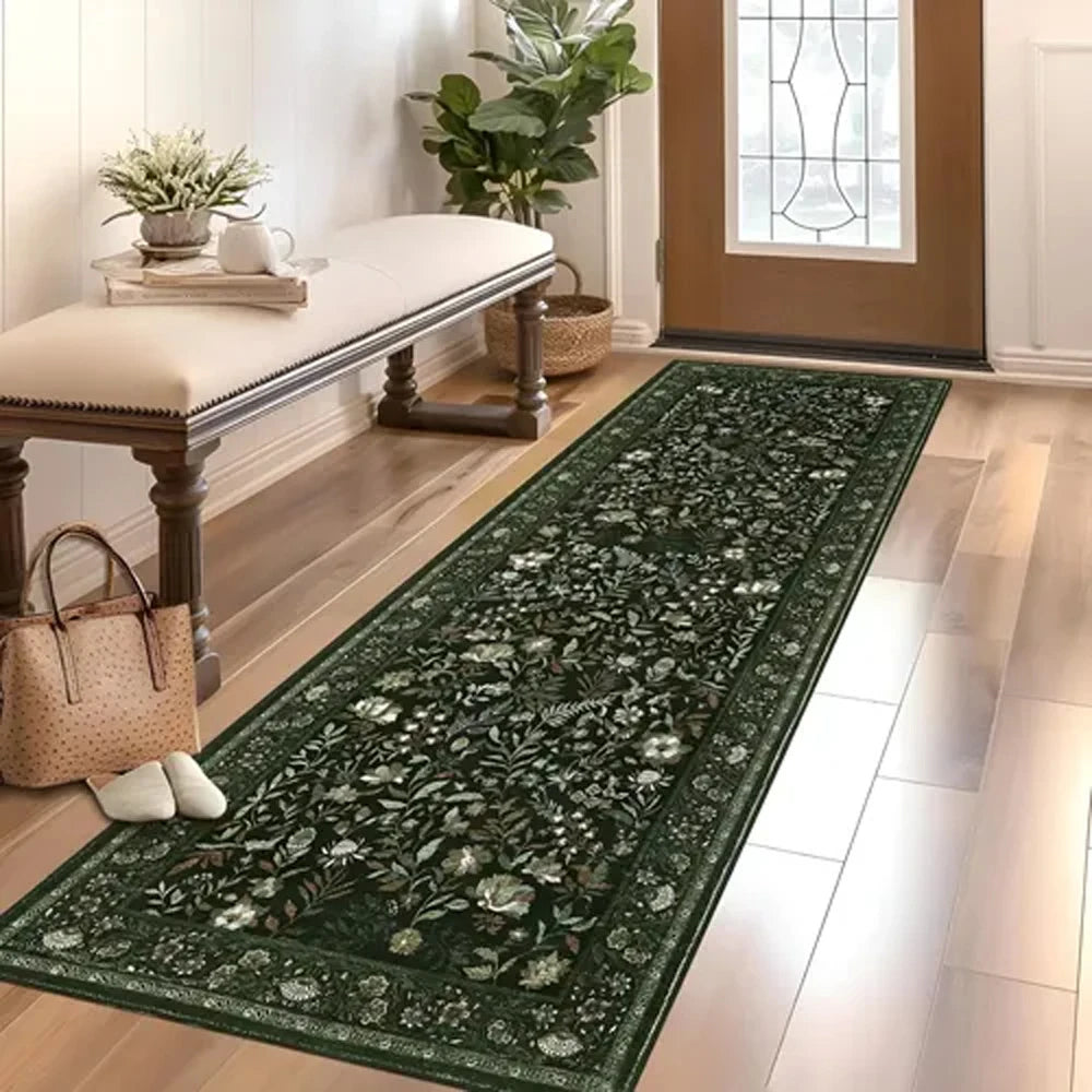 A dark green vintage botanical runner rug laid on a light wood floor in a bright room.