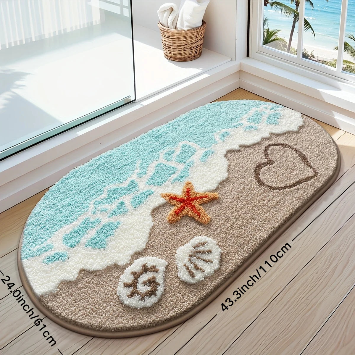 A beige bathroom rug with a blue wave design, heart, and starfish accents on a wooden floor.