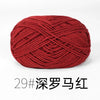 A ball of deep red, tightly twisted knitting yarn for crafts.