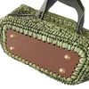 A square woven bag with a brown lining and green textured exterior, featuring hanging hooks.