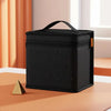 A black portable marker storage pouch with a zipper is displayed on a wooden surface.
