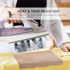 A hand is placing a brown heat press transfer sheet onto a yellow fabric, demonstrating the heat and tear resistant quality.