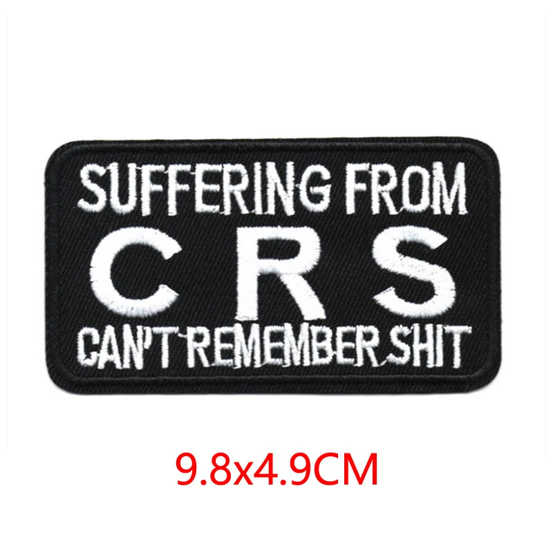 Black iron-on embroidered letter patch with white text reading SUFFERING FROM CRS CAN'T REMEMBER SHIT