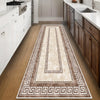 A long rectangular area rug with a geometric pattern in beige and brown tones placed on a wooden floor in a modern kitchen.