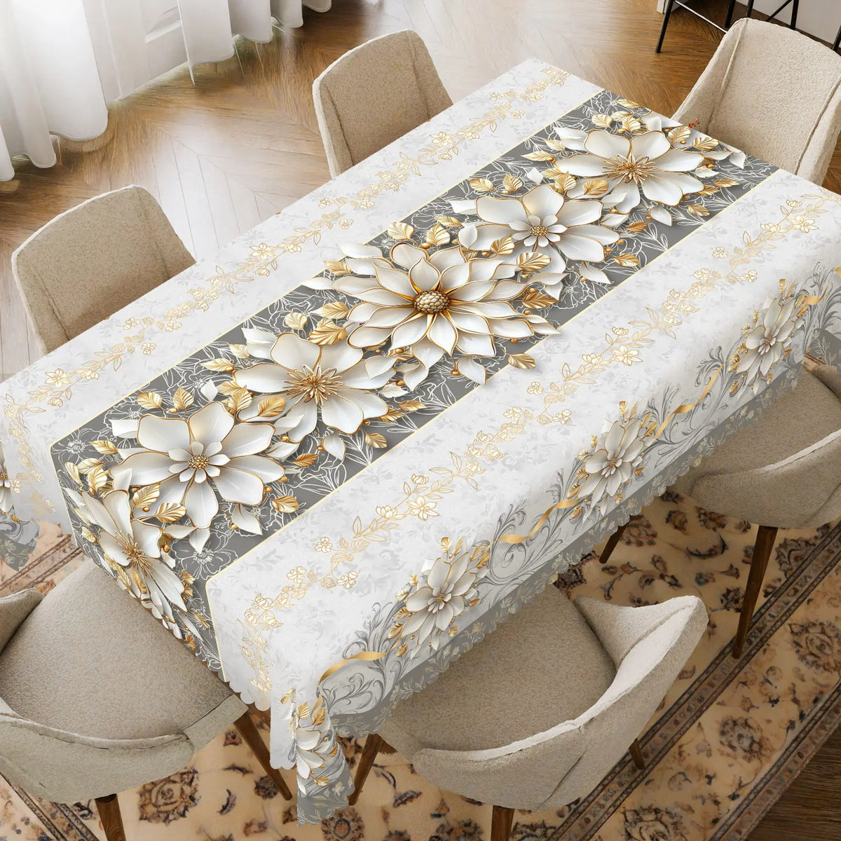 Elegant floral tablecloth with silver and gold embossed edges set on a wooden dining table.