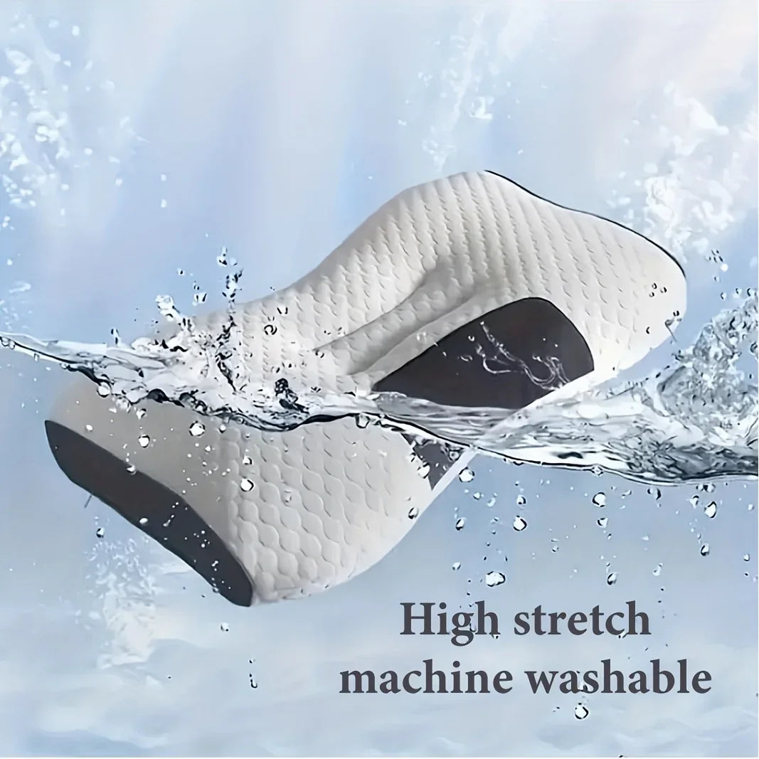 A white massage pillow is shown being washed under water, highlighting its high stretch and machine washable feature.