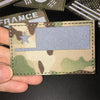 A tactical patch featuring the flag of France on a camouflage background.