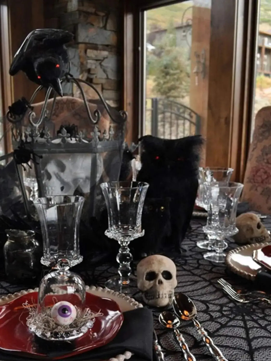 Black spider web lace table runner displayed on a dark tablecloth with skull accents.