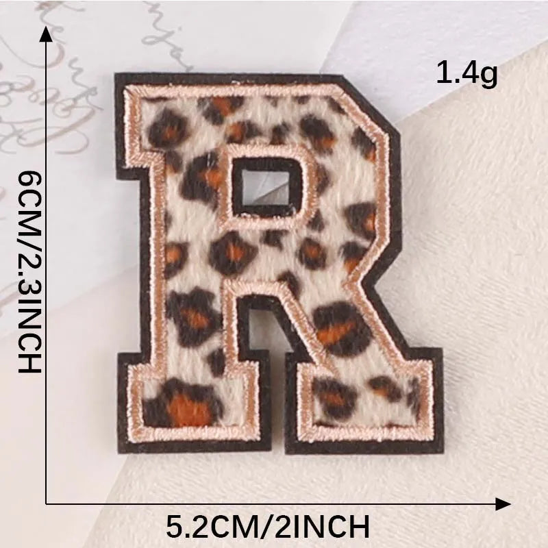 A leopard print alphabet iron-on patch shaped like the letter R, measuring 1.4 grams and 5.2 cm.