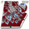 Red cotton satin grand wax print fabric featuring intricate silver and blue patterns