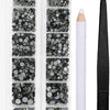A clear plastic container holds various sizes of dark and silver crystal hot fix rhinestones and an applicator tool.