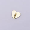 A small, polished gold-colored metal heart charm with a cylindrical connector attached.