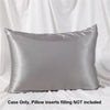A smooth, gray satin pillowcase is displayed against a white draped background.