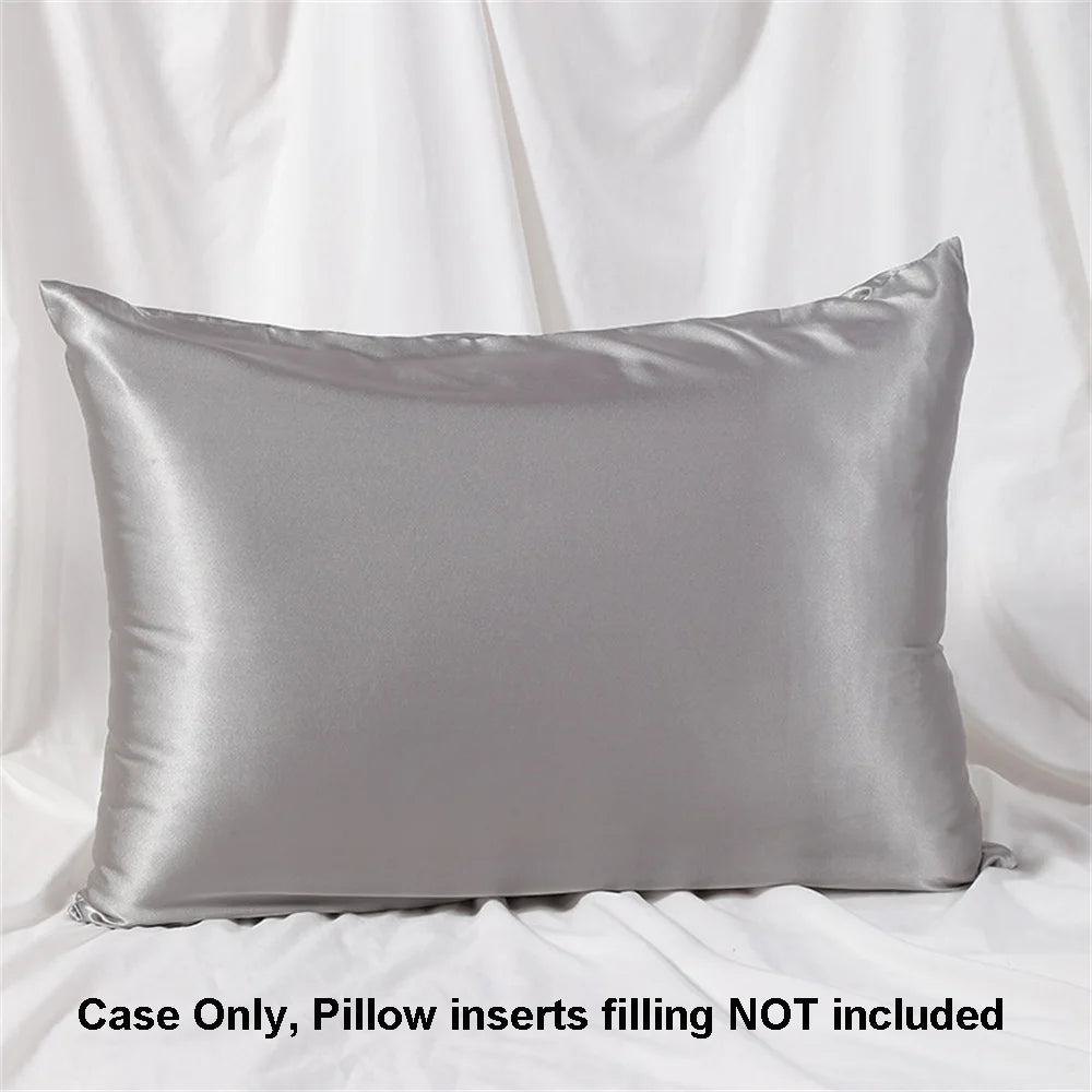 A smooth, gray satin pillowcase is displayed against a white draped background.