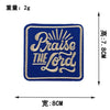 A dark blue embroidered patch with gold lettering that reads Praise The Lord