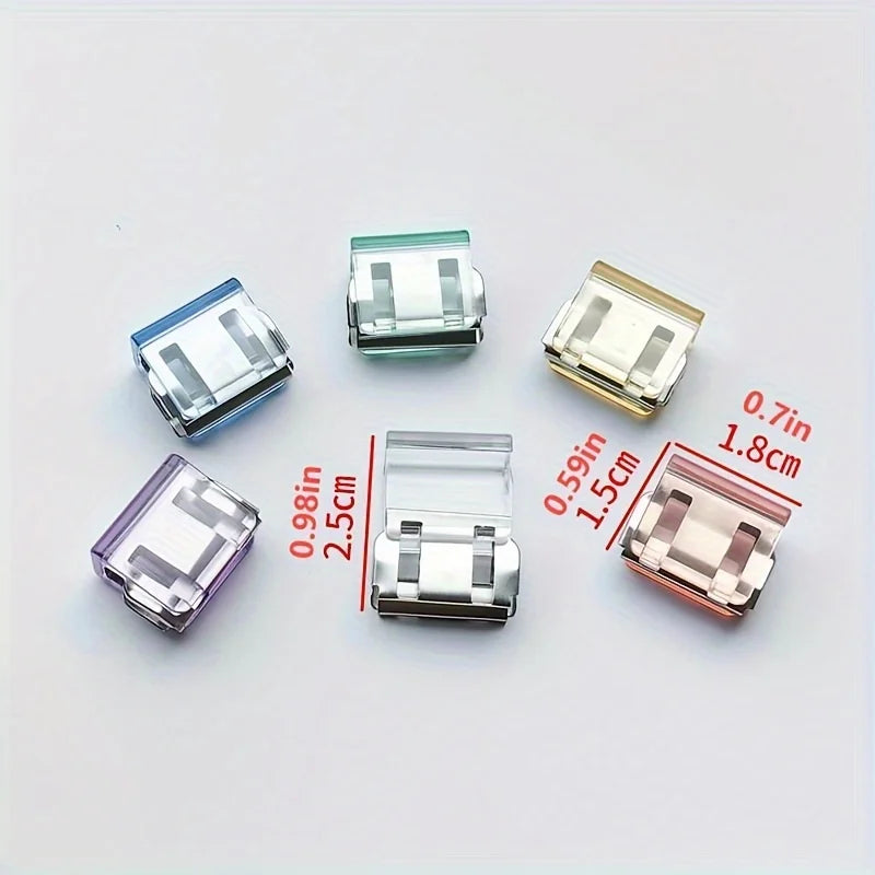 A collection of various clear and colored invisible hem shortening clips displayed on a white background.