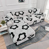 L-shaped sofa protector covers featuring a gray and black floral pattern on a light gray sofa.